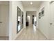 Inviting hallway with wood-look tile, decorative mirrors, and an open view into the living area at 486 Disa Dr, Davenport, FL 33837