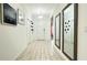 Bright hallway with neutral tile flooring, modern light fixtures, and decorative mirrors at 486 Disa Dr, Davenport, FL 33837