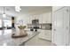 Modern kitchen featuring white cabinets, granite counters, and views of the dining area at 486 Disa Dr, Davenport, FL 33837