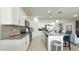 Bright kitchen featuring white cabinets, granite countertops, and stainless steel appliances at 486 Disa Dr, Davenport, FL 33837