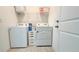 Laundry room features a full-size washer and dryer, storage space and lots of lighting at 486 Disa Dr, Davenport, FL 33837