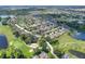 Aerial view of a residential neighborhood, showcasing lush landscaping, and proximity to a golf course and lakes at 514 Cadiz Dr, Davenport, FL 33837