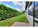 A serene backyard bordered by lush hedges, offering a private outdoor space at 514 Cadiz Dr, Davenport, FL 33837