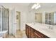 Bathroom featuring double sinks, brown wood cabinets, shower, and tile flooring at 514 Cadiz Dr, Davenport, FL 33837