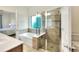 Bright bathroom boasts a soaking tub, a walk-in shower, and tile flooring at 514 Cadiz Dr, Davenport, FL 33837