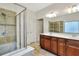 Beautiful bathroom featuring double sinks, white countertop, shower, and tile flooring at 514 Cadiz Dr, Davenport, FL 33837