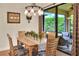 Bright dining area with glass sliders to lanai, wooden table and decorative lighting at 514 Cadiz Dr, Davenport, FL 33837
