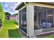 Exterior view of the screened lanai and serene backyard landscaping at 514 Cadiz Dr, Davenport, FL 33837
