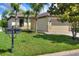 Inviting single-story home featuring a manicured lawn, palm trees, and a charming mailbox on a sunny day at 514 Cadiz Dr, Davenport, FL 33837