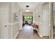 Inviting hallway with light walls, wood floors, and view to living room with large window and modern decor at 514 Cadiz Dr, Davenport, FL 33837