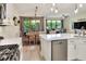 Open concept kitchen with stainless dishwasher, range, and access to outdoor patio at 514 Cadiz Dr, Davenport, FL 33837