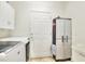 Bright laundry area featuring white cabinetry, modern washer and dryer, and convenient storage solutions at 514 Cadiz Dr, Davenport, FL 33837