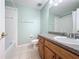 Well-lit bathroom featuring a vanity with a sink, toilet, shower, and neutral color scheme at 532 Kildrummy Dr, Davenport, FL 33896