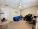 Bedroom featuring a ceiling fan, a desk with a computer, and a twin size bed at 532 Kildrummy Dr, Davenport, FL 33896