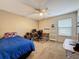 Bedroom featuring a ceiling fan, a desk with a computer, and a large window at 532 Kildrummy Dr, Davenport, FL 33896