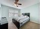 Bedroom with a large window, a ceiling fan, and a large dark wood bed frame at 532 Kildrummy Dr, Davenport, FL 33896
