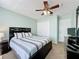 Bedroom featuring dark wood furniture, a ceiling fan, and a neutral color scheme at 532 Kildrummy Dr, Davenport, FL 33896