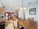 Open concept with kitchen, stainless steel appliances and adjacent dining area with a view to living room at 532 Kildrummy Dr, Davenport, FL 33896