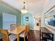 Cozy dining area with views to the kitchen and window, complete with wood floors and updated chandelier at 532 Kildrummy Dr, Davenport, FL 33896