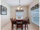 Simple dining area featuring a wood table, window and tile floors, perfect for casual meals at 532 Kildrummy Dr, Davenport, FL 33896