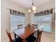 Light-filled dining area boasting tile flooring, backyard views and an elegant chandelier at 532 Kildrummy Dr, Davenport, FL 33896