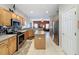 Modern kitchen featuring stainless steel appliances, granite countertops, a kitchen island, and an open layout at 532 Kildrummy Dr, Davenport, FL 33896