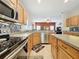 Open concept kitchen with granite countertops, stainless steel appliances, and ample cabinet space at 532 Kildrummy Dr, Davenport, FL 33896