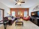 Open living room boasts a red accent wall, updated lighting, and cozy seating perfect for relaxing at 532 Kildrummy Dr, Davenport, FL 33896