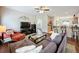 Inviting living room featuring hardwood floors and an open view into the kitchen and dining area at 532 Kildrummy Dr, Davenport, FL 33896