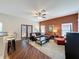 Open living room with hardwood floors, ceiling fan, stylish furniture, and glass coffee table at 532 Kildrummy Dr, Davenport, FL 33896