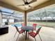 Relaxing covered patio with a ceiling fan, outdoor seating, and a view of the sparkling pool at 532 Kildrummy Dr, Davenport, FL 33896