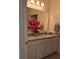 Bathroom with double sinks, granite countertops, and modern fixtures at 5539 Maddie Dr, Haines City, FL 33844