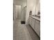The bathroom has a glass door walk-in shower and white cabinets under a granite countertop sink at 5539 Maddie Dr, Haines City, FL 33844