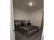 Bedroom with gray floors, gray bedframe, dark bedding, and neutral paint at 5539 Maddie Dr, Haines City, FL 33844