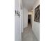 Hallway with neutral paint, gray flooring, decorative wall art, and a key holder at 5539 Maddie Dr, Haines City, FL 33844
