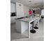 Modern kitchen island with granite countertops, seating for two, and contemporary lighting fixtures at 5539 Maddie Dr, Haines City, FL 33844