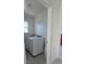 Laundry room featuring modern, front-loading white washer and dryer with a window for natural light at 5539 Maddie Dr, Haines City, FL 33844