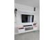 Modern living room featuring a mounted TV, fireplace, and a decorative plant at 5539 Maddie Dr, Haines City, FL 33844