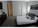 Modern main bedroom with a black bed frame, gray carpet, and black and white decor at 5539 Maddie Dr, Haines City, FL 33844
