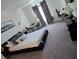 Spacious main bedroom with a gray carpet, decor, and large windows with gray curtains at 5539 Maddie Dr, Haines City, FL 33844