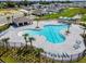 Resort-style pool area with palm trees, lounge chairs, and shaded cabanas in a serene community setting at 5539 Maddie Dr, Haines City, FL 33844