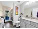 Bathroom with granite vanity, framed mirror, and decorative wall art at 5801 N Kenansville Rd, St Cloud, FL 34773