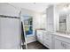Bathroom featuring dual sinks, granite countertops, and a walk-in shower at 5801 N Kenansville Rd, St Cloud, FL 34773