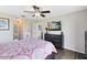Bedroom features wood floors, ceiling fan, dresser, and TV at 5801 N Kenansville Rd, St Cloud, FL 34773