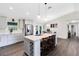 Modern kitchen with a large island, stainless steel appliances, and seamless connection to dining area at 5801 N Kenansville Rd, St Cloud, FL 34773