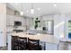 Beautiful kitchen with stainless steel appliances, an island with bar seating, and modern white cabinetry at 5801 N Kenansville Rd, St Cloud, FL 34773