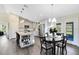 Bright, open kitchen with stainless steel appliances, white cabinetry, island, and adjacent dining area at 5801 N Kenansville Rd, St Cloud, FL 34773