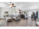 Open-concept living area with hardwood floors, plush sofas, and a modern kitchen island at 5801 N Kenansville Rd, St Cloud, FL 34773
