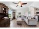 Comfortable living room with hardwood floors, soft gray sofas, and a large window with natural light at 5801 N Kenansville Rd, St Cloud, FL 34773