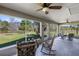 Screened patio with ceiling fans, comfortable chairs, and views of the spacious backyard at 5801 N Kenansville Rd, St Cloud, FL 34773